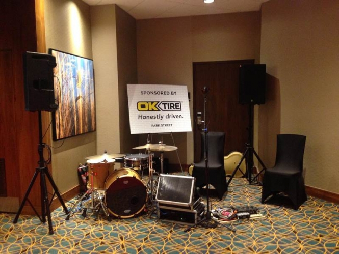 Ok Tire & Auto Service sponsor logo with band instruments