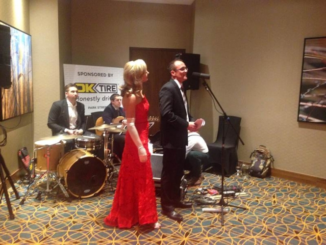 Ok Tire & Auto Service sponsored event organizers with band