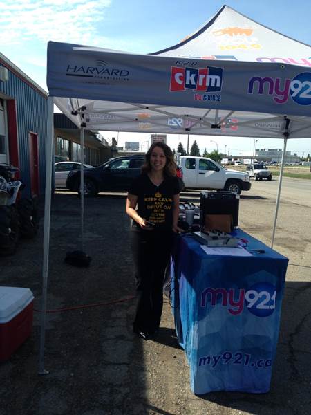 Girl in fair in front of Ok Tire & Auto Service