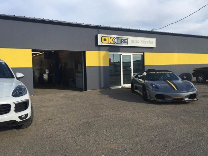 Ok Tire & Auto Service front with exotic cars